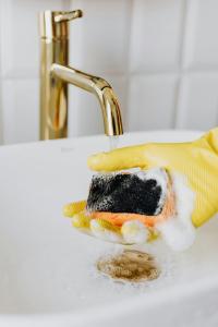 a piece of cake on a plate in front of a sink at Le Ponsardin in Reims