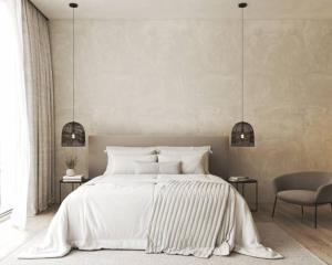 a bedroom with a white bed and a chair at Le Ponsardin in Reims