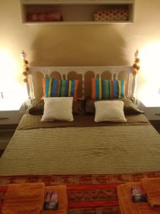 a large bed with two pillows on top of it at La Chili in Salta