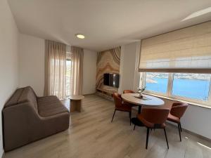 a living room with a couch and a table at Apartments by Resort Čulina in Metajna