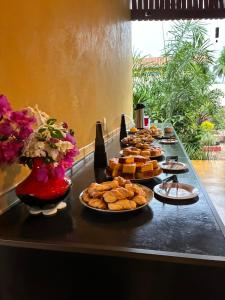 a table with a bunch of food on it at Pousada dos Bougainvilles in Manhã