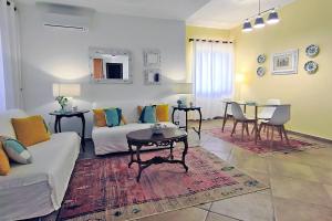 a living room with a couch and a table at Villa Paradiso in Scopello