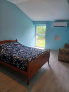 a bedroom with a bed in a room with a window at Chez Pépé in Limalonges