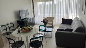 a living room with a couch and a table at Pine Residence at Lav Meridien Resort in Podstrana