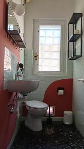 a bathroom with a toilet and a sink and a window at B&B Velocipede in Cervignano del Friuli +11 photos