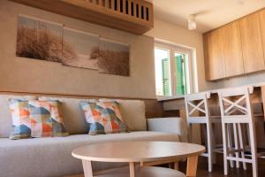 a living room with a couch and a table at Apartment Solis 6 in Stara Novalja
