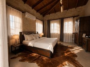 a bedroom with a large bed in a room with windows at LA BİEN ALAÇATI by ALİİS in Çeşme +56 photos