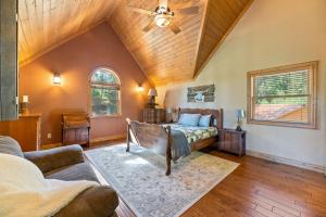 a bedroom with a bed and a ceiling fan at Destiny Luxury Log Cabin in Sturgis