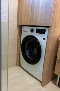 a washing machine in a cabinet in a room at Apartment Solis 6 in Stara Novalja