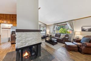 a living room with a fireplace and a couch at Cozy Pines & Paths Retreat in South Lake Tahoe