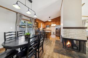 a dining room with a fireplace and a table and chairs at Cozy Pines & Paths Retreat in South Lake Tahoe