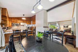 a kitchen and living room with a table and chairs at Cozy Pines & Paths Retreat in South Lake Tahoe +21 photos