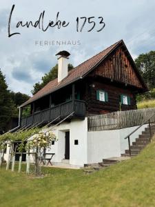 a log house with a balcony on top of it at Ferienhaus Landliebe 1753 in Bad Gleichenberg