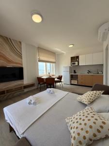 a room with two beds and a kitchen with a table at Apartments by Resort Čulina in Metajna
