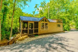 a cabin in the woods with a driveway at Serenity at the Smokies in Sevierville