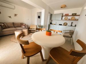 a living room with a white table and chairs at Halo Tinos - ARTEMIS in Tinos