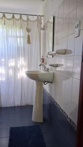 a bathroom with a white sink and a mirror at la riviere in Alta Gracia +27 photos