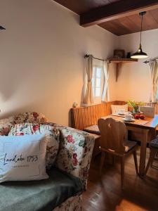 a living room with a couch and a table at Ferienhaus Landliebe 1753 in Bad Gleichenberg +13 photos