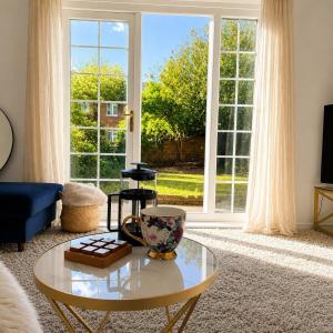 a living room with a coffee table and a large window at Modern 3BR Close to Durham Centre in Gilesgate