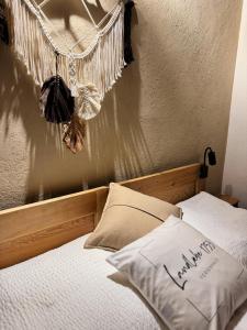 a bed with a wooden headboard with a pillow on it at Ferienhaus Landliebe 1753 in Bad Gleichenberg