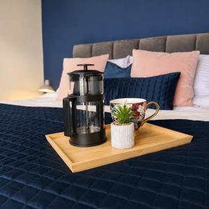a coffee maker and a cup on a tray on a bed at Modern 3BR Close to Durham Centre in Gilesgate +18 photos