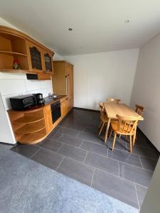 a kitchen with a table and a table and chairs at Monteurzimmer\Ferienwohnung in Bad Gandersheim