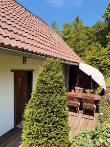 a wooden deck with a table and an umbrella at Ferienhaus Landliebe 1753 in Bad Gleichenberg