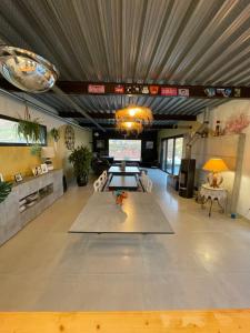 a large living room with a table in the middle at Villa Millau-gorges du Tarn in Aguessac