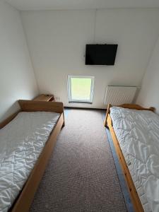 a room with two beds and a flat screen tv at Monteurzimmer\Ferienwohnung in Bad Gandersheim