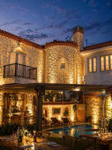 a large stone building with a pool in front of it at LA BİEN ALAÇATI by ALİİS in Çeşme