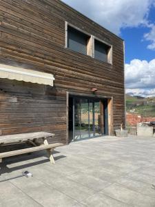 a wooden building with a bench in front of it at Villa Millau-gorges du Tarn in Aguessac +1 photo