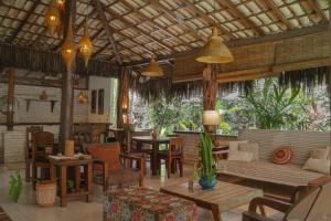 a living room with a couch and chairs and tables at Na Villa dos Algodões in Marau