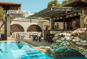 a resort with a swimming pool and a restaurant at Grantzaos Villas in Laganas
