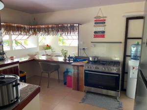 a kitchen with a stove and a counter top at Fare Te Vaite in Tikehau Airport