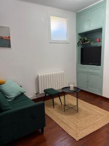 a living room with a couch and a table at Apartamento Nordés in A Guarda