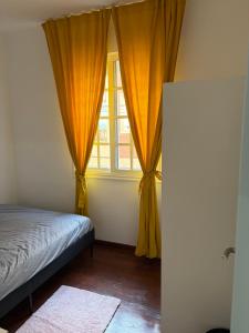 a bedroom with a bed and a window with curtains at Apartamento Nordés in A Guarda