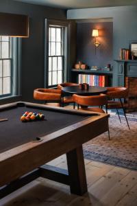 a room with a pool table and chairs at Old Dutch Inn in Kinderhook