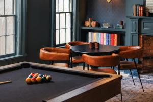 a room with a pool table and a table and chairs at Old Dutch Inn in Kinderhook +51 photos