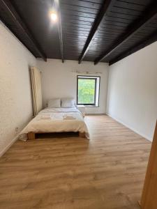 a bedroom with a bed and a window at Himalaya Budget Inn in Niederanven +3 photos