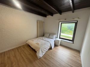 a small bedroom with a bed and a window at Himalaya Budget Inn in Niederanven