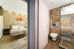 a bathroom with a bed and a shower and a toilet at Solere Apartments in Limenaria +89 photos