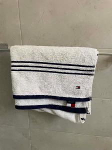 a towel hanging on a towel rack in a bathroom at Modern Rooftop with Stunning View Iconic Tower in Madīnat aţ Ţalāʼi‘ +6 photos
