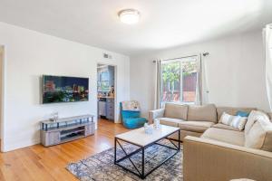 a living room with a couch and a table at Midtown Sanctuary w Pac-Man in Reno