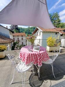 a table with a red and white checkered table cloth at Da Anny - Valdilana in Coggiola