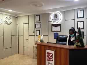 a woman wearing a face mask sitting at a counter at Bays Lodge, Accra in Accra +273 photos