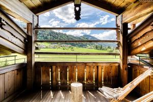 a view from the inside of a wooden building with a window at Naturresort PURADIES in Leogang