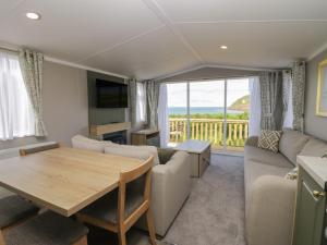 a living room with a couch and a table at The Swift in St Bees