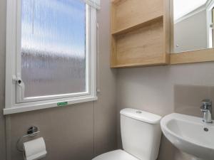 a bathroom with a toilet and a sink and a window at The Swift in St Bees +26 photos