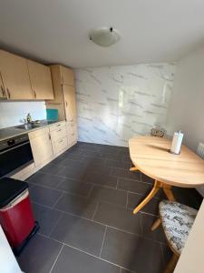 a small kitchen with a wooden table and a counter at Monteurzimmer Ferienwohnung in Bad Gandersheim