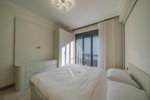 a bedroom with a bed and a large window at Luku Villa in Sapanca +25 photos